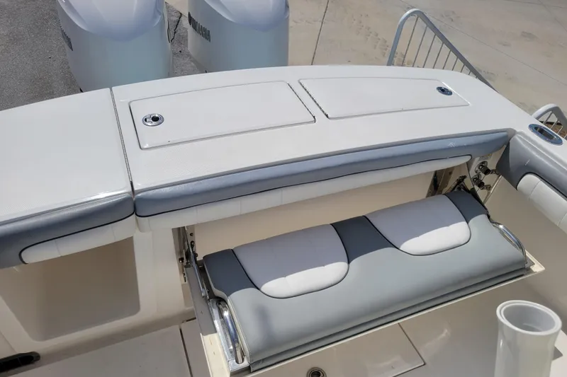 Slide: The Image of 2018 Regulator 28 Forward Seating boat with foldable bench and storage compartments. - 5