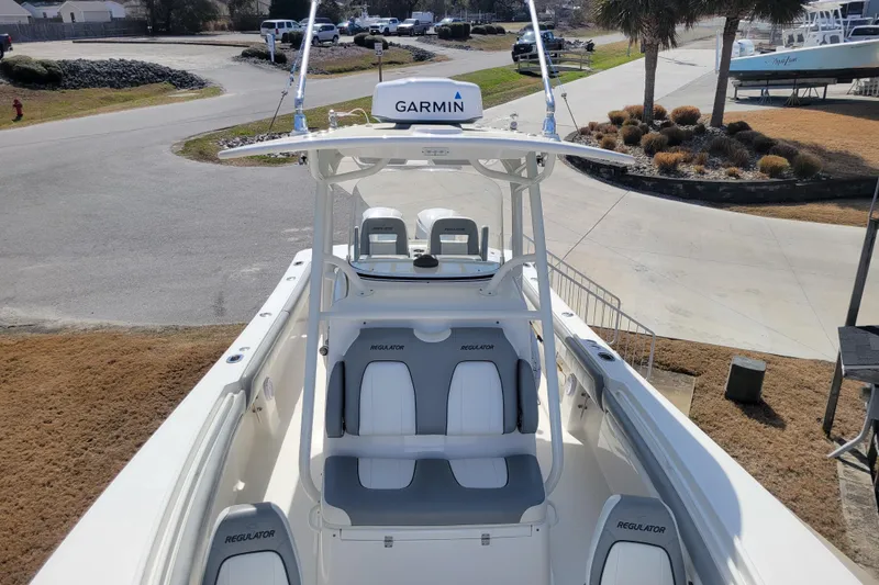 Slide: The Image of 2018 Regulator 28 Forward Seating boat with Garmin equipment, docked on a sunny day. - 7