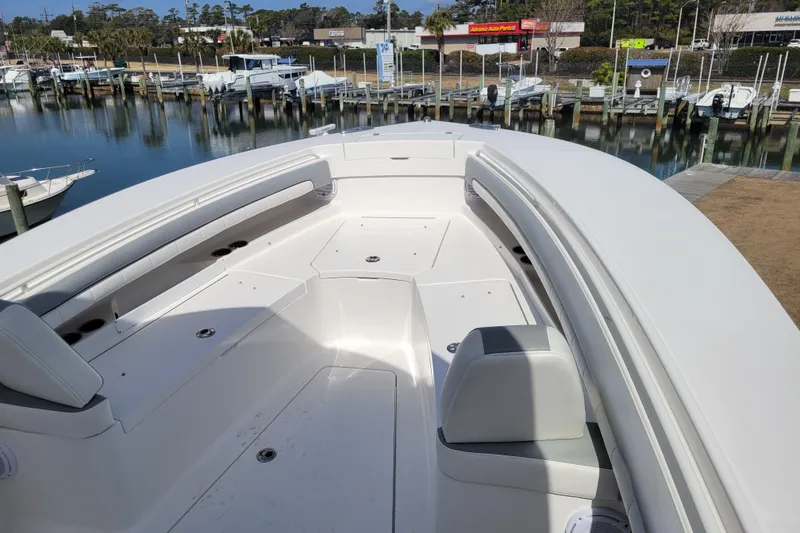 Slide: The Image of 2018 Regulator 28 Forward Seating boat with spacious deck and marina view. - 9