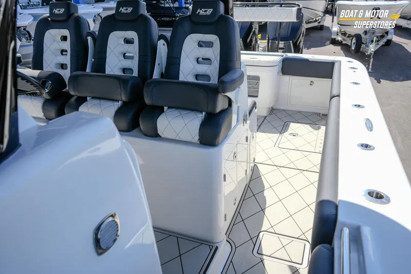 Slide: The Image of 2023 HCB 39 Speciale boat interior with cushioned seating and storage compartments. - 104