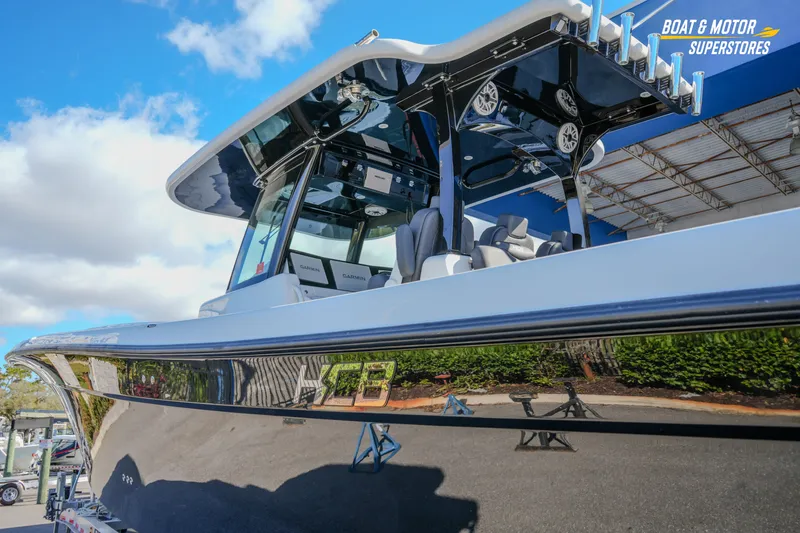 Slide: The Image of 2023 HCB 39 Speciale boat on trailer at dealership under blue sky. - 11