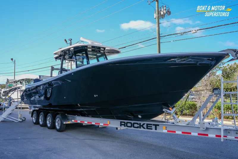 Slide: The Image of 2023 HCB 39 Speciale boat with luxurious seating and modern design at a dealership. - 18