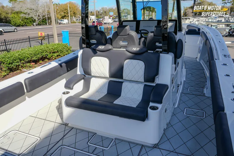 Slide: The Image of 2023 HCB 39 Speciale boat with dual Mercury Verado engines, docked at a marina. - 24