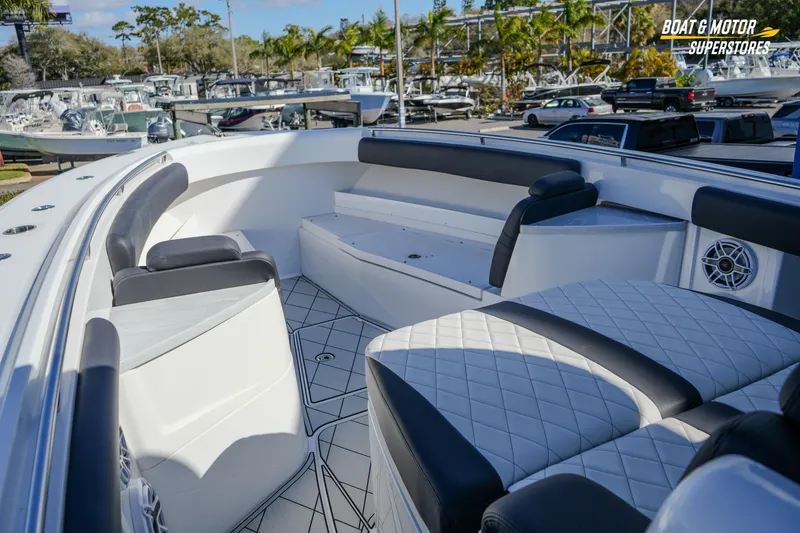 Slide: The Image of 2023 HCB 39 Speciale boat with luxurious seating and sleek design at a dealership. - 51