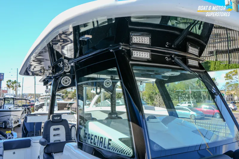 Slide: The Image of 2023 HCB 39 Speciale boat interior with seating and storage, displayed at a dealership. - 64
