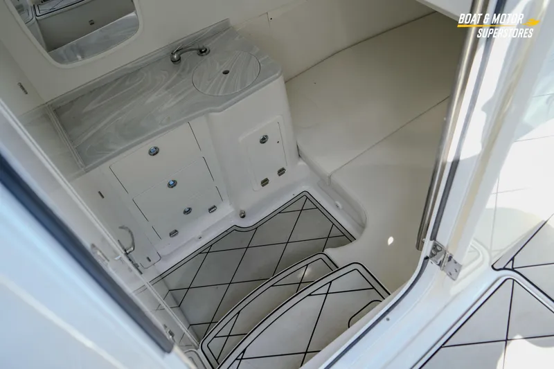 Slide: The Image of 2023 HCB 39 Speciale boat interior with sink, storage, and cushioned seating area. - 85