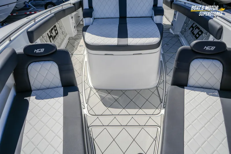 Slide: The Image of 2023 HCB 39 Speciale boat at dealership, featuring advanced navigation equipment under clear skies. - 95