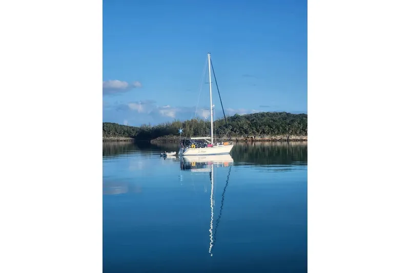 Slide: The Image of 1989 Catalina 42 sailboat docked at marina, covered mainsail, clear blue sky. - 14