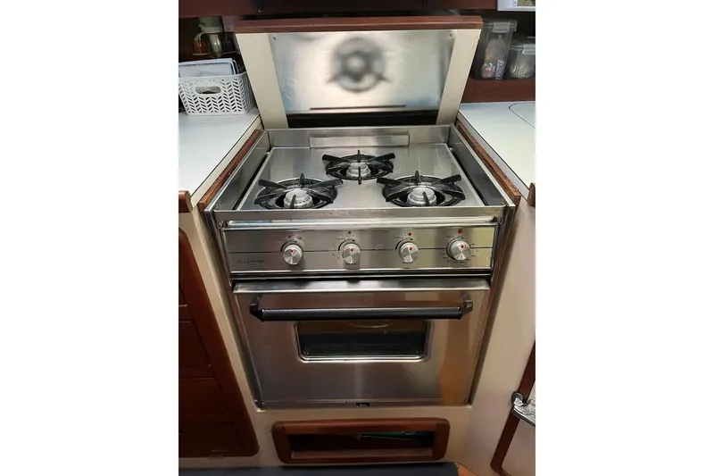 Slide: The Image of Interior of 1989 Catalina 42 MkII sailboat galley with stove, sink, and microwave. - 29