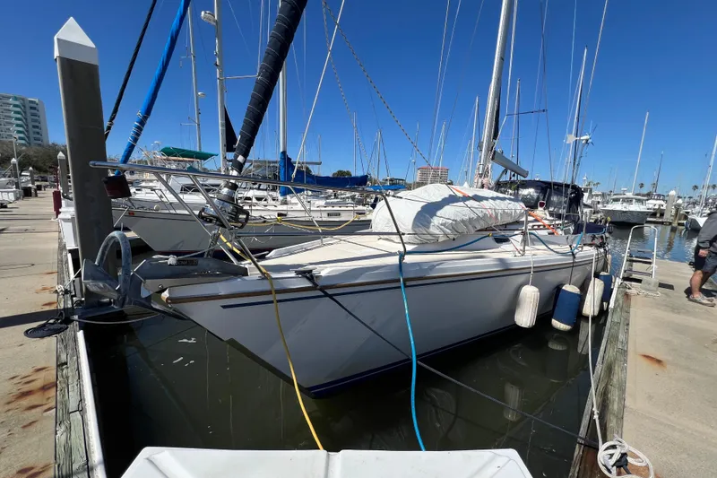 Slide: The Image of Sailboats anchored in clear blue water, featuring a 1989 Catalina 42 model. - 3