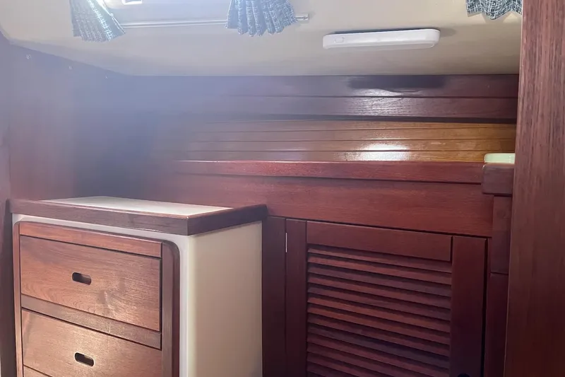 Slide: The Image of Cabinet storage in a 1989 Catalina 42 yacht with food containers and a digital thermometer. - 33