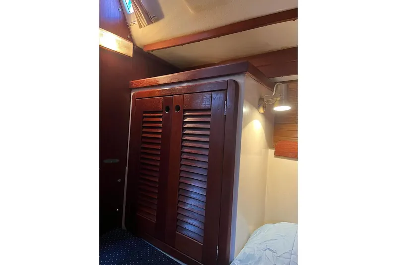 Slide: The Image of Wooden cabinet inside 1989 Catalina 42 MkII sailboat cabin, with ambient lighting. - 34
