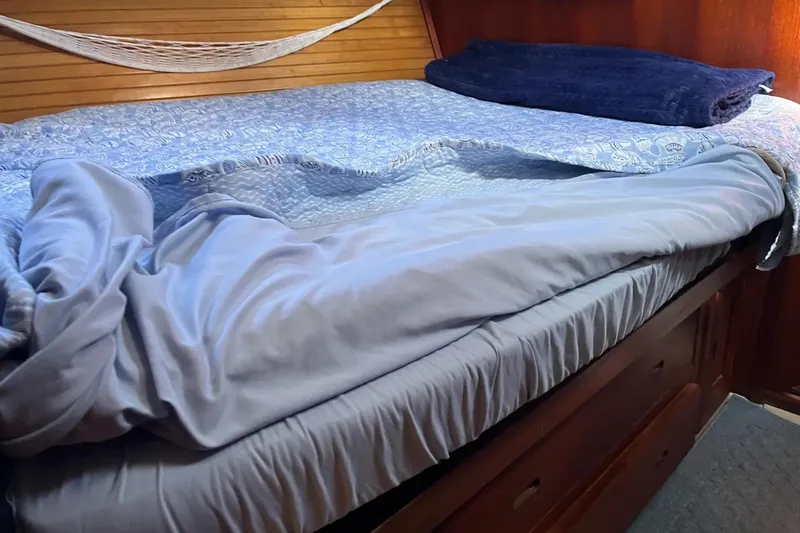 Slide: The Image of Cozy cabin interior of a 1989 Catalina 42 sailboat with nautical decor and skylights. - 35