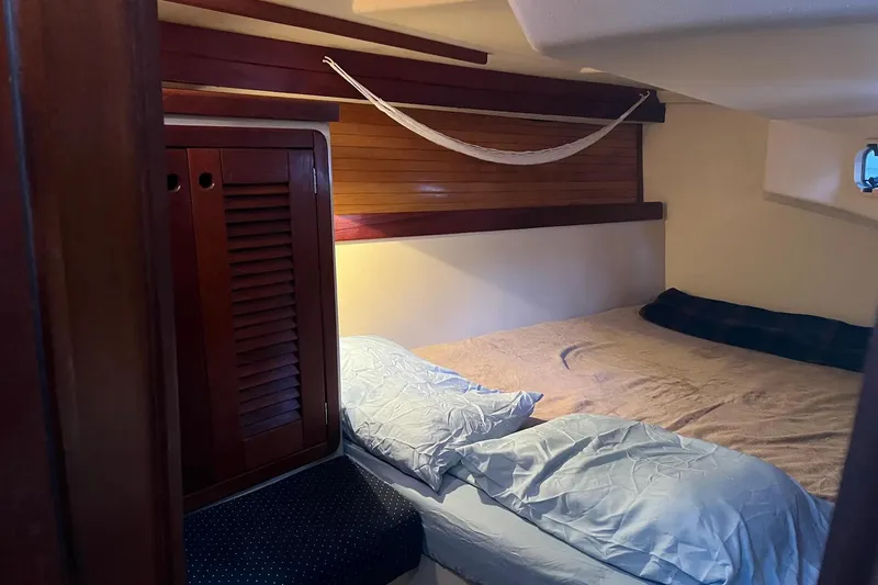 Slide: The Image of Cozy cabin interior of 1989 Catalina 42 sailboat with nautical decor and bedding. - 36