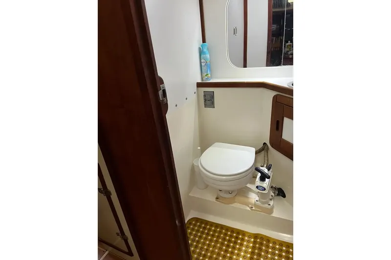 Slide: The Image of Cozy cabin interior of 1989 Catalina 42 sailboat with bed, hammock, and porthole windows. - 38