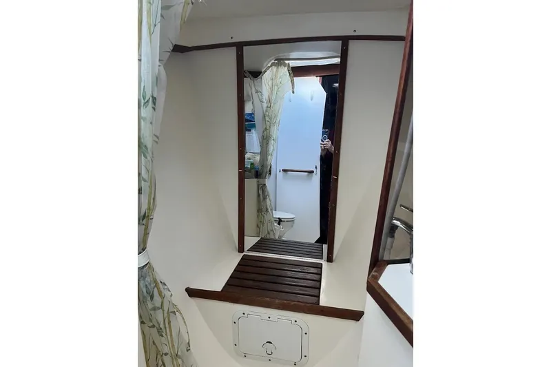 Slide: The Image of Cozy cabin interior of 1989 Catalina 42 sailboat with bed and porthole windows. - 39