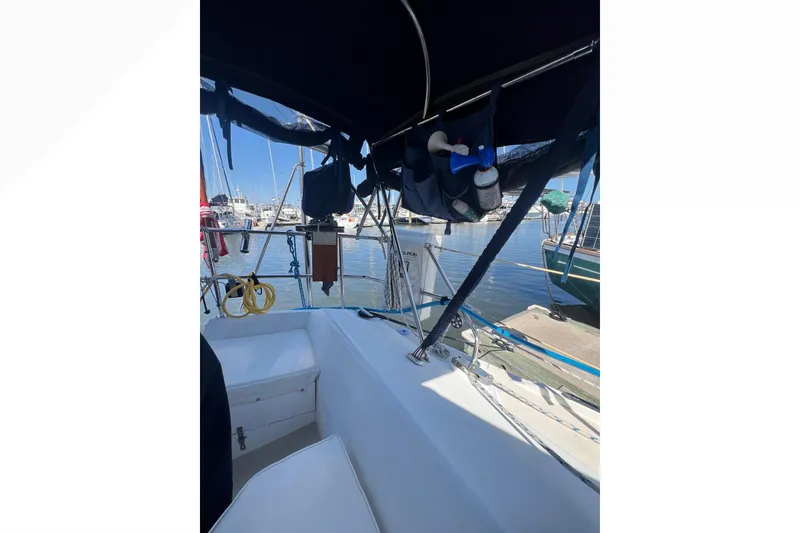 Slide: The Image of Bathroom sink area in a 1989 Catalina 42 yacht, featuring a mirror and toiletries. - 47