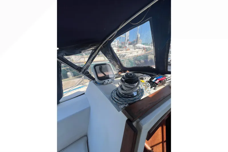 Slide: The Image of Cozy cabin bed in a 1989 Catalina 42 sailboat with blue bedding and wooden accents. - 48