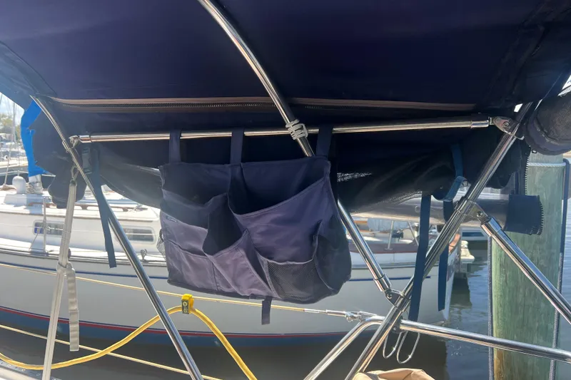 Slide: The Image of Electrical control panel of a 1989 Catalina 42 yacht, featuring various switches and meters. - 52