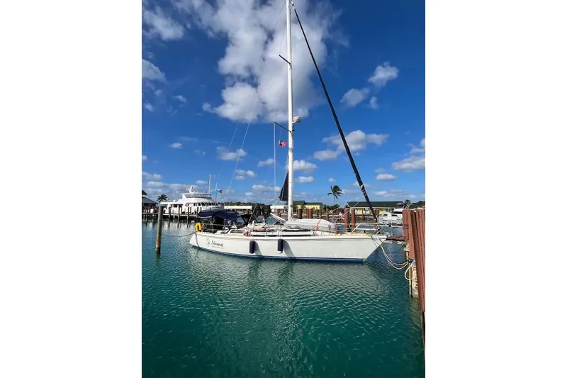 Slide: The Image of Sailboats docked at marina under clear blue sky, featuring a 1989 Catalina 42. - 6