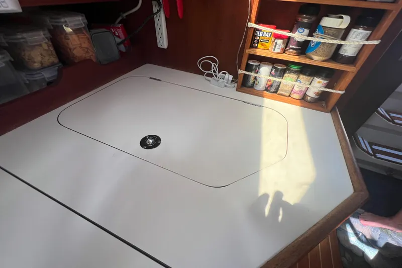 Slide: The Image of Engine compartment of a 1989 Catalina 42 sailboat, showcasing mechanical components. - 62