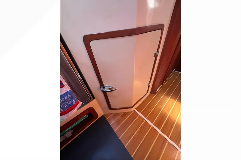 Slide: The Image of Engine compartment of a 1989 Catalina 42 sailboat, showcasing mechanical components and wiring. - 63