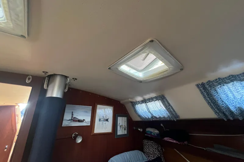 Slide: The Image of Engine compartment of a 1989 Catalina 42 sailboat, featuring a Yanmar diesel engine. - 65