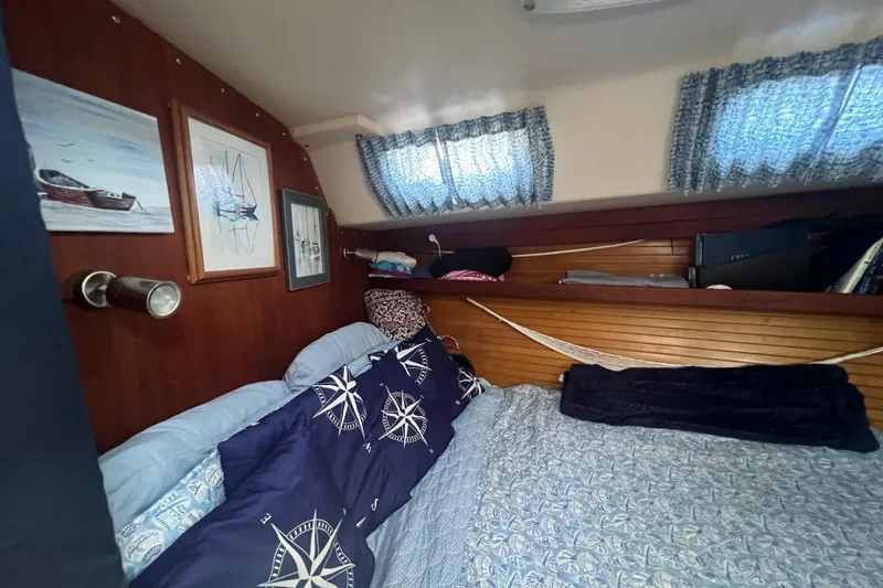 Slide: The Image of Engine compartment of a 1989 Catalina 42 sailboat, showcasing mechanical components and wiring. - 66