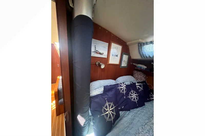 Slide: The Image of Deck detail of a 1989 Catalina 42 sailboat with textured surface and metal fittings. - 68