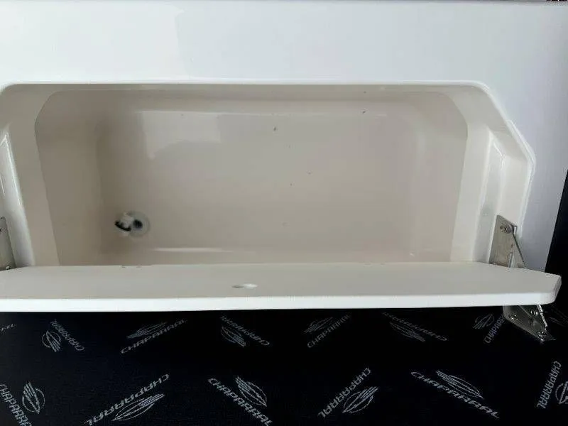 Slide: The Image of Chaparral SSX 30 2026 boat hatch with storage compartment. - 39