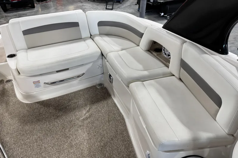 Slide: The Image of 2008 Chaparral 284 Sunesta boat interior with white cushioned seating and carpeted floor. - 11