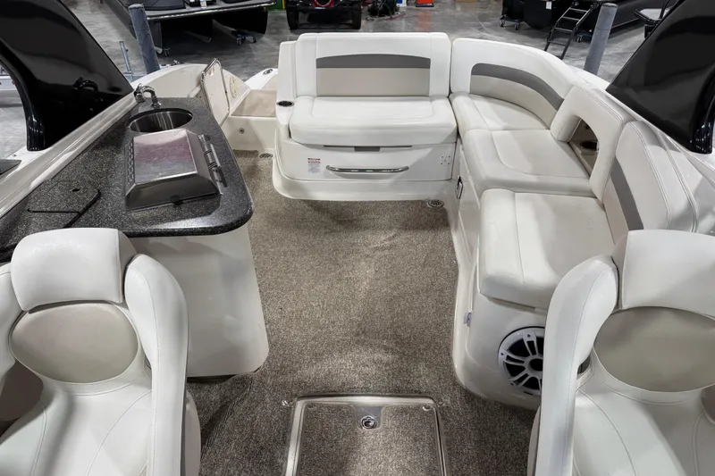 Slide: The Image of 2008 Chaparral 284 Sunesta boat interior with seating and kitchenette area. - 12