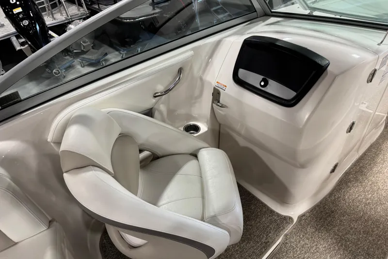 Slide: The Image of 2008 Chaparral 284 Sunesta boat interior with white seating and dashboard. - 14