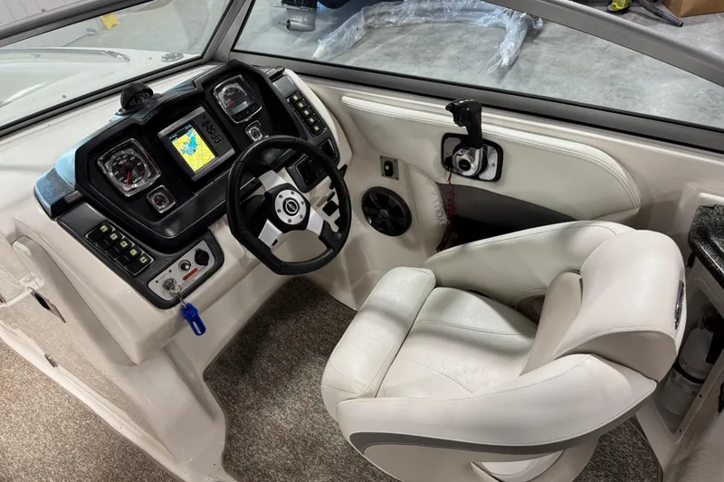 Slide: The Image of 2008 Chaparral 284 Sunesta boat cockpit with steering wheel and navigation system. - 15
