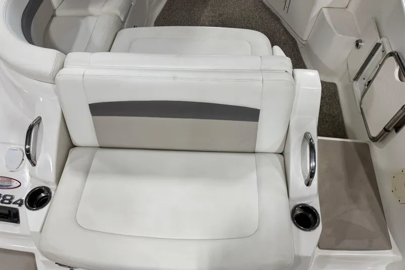Slide: The Image of 2008 Chaparral 284 Sunesta boat interior with white seating and cup holders. - 8
