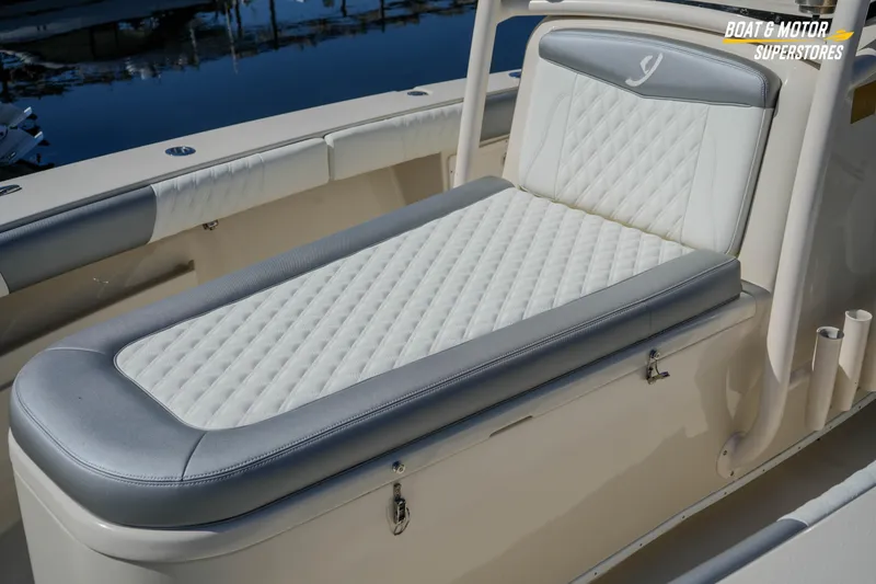 Slide: The Image of Luxurious seating on a 2016 Young 27 boat, featuring quilted upholstery and sleek design. - 12