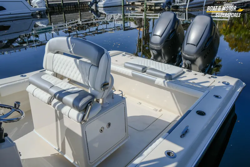 Slide: The Image of Luxury 2016 Young 27 boat interior with dual engines at a marina. - 14