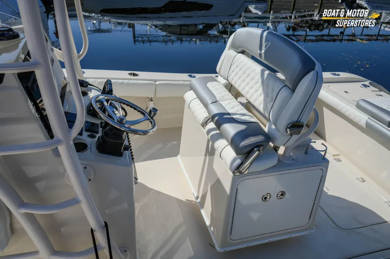 Slide: The Image of 2016 Young 27 boat interior with steering wheel and cushioned seating. - 16