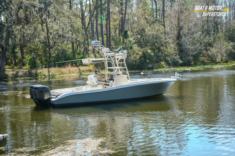 Slide: The Image of 2016 Young 27 boat cruising on a serene forested river. - 23