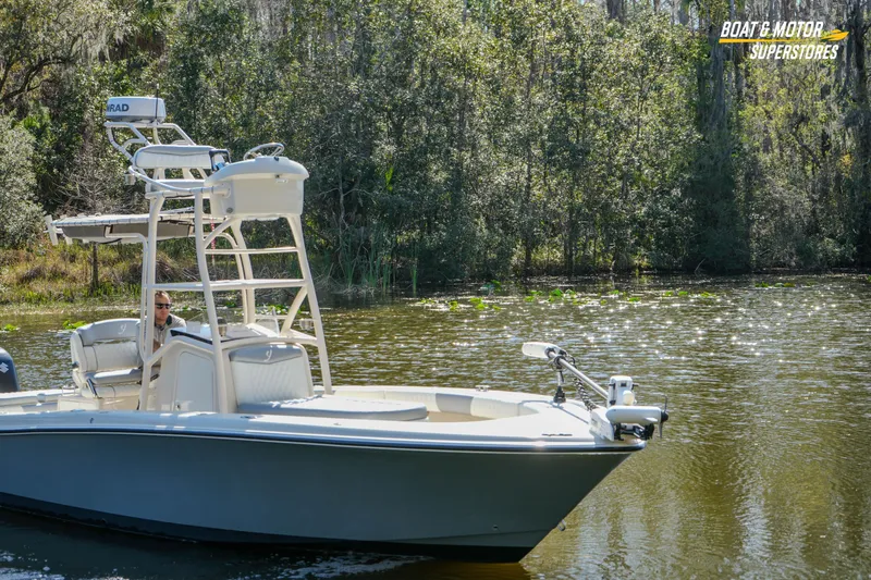 Slide: The Image of Boat on a serene lake, surrounded by lush greenery, under clear skies. - 28