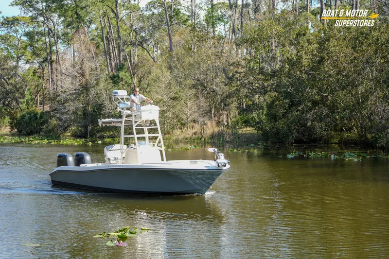 Slide: The Image of A 2016 Young 27 boat navigating a serene, tree-lined waterway. - 29