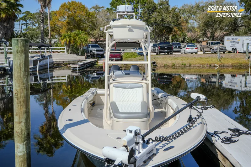Slide: The Image of 2016 Young 27 boat docked at marina, surrounded by trees and parked vehicles. - 7