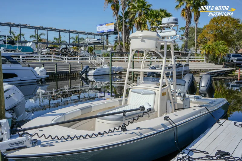 Slide: The Image of Young 27 boat docked at marina, surrounded by palm trees and clear blue sky. - 8
