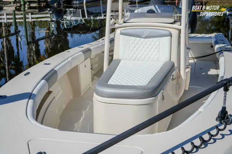 Slide: The Image of 2016 Young 27 boat with cushioned seating, docked at a marina. - 10