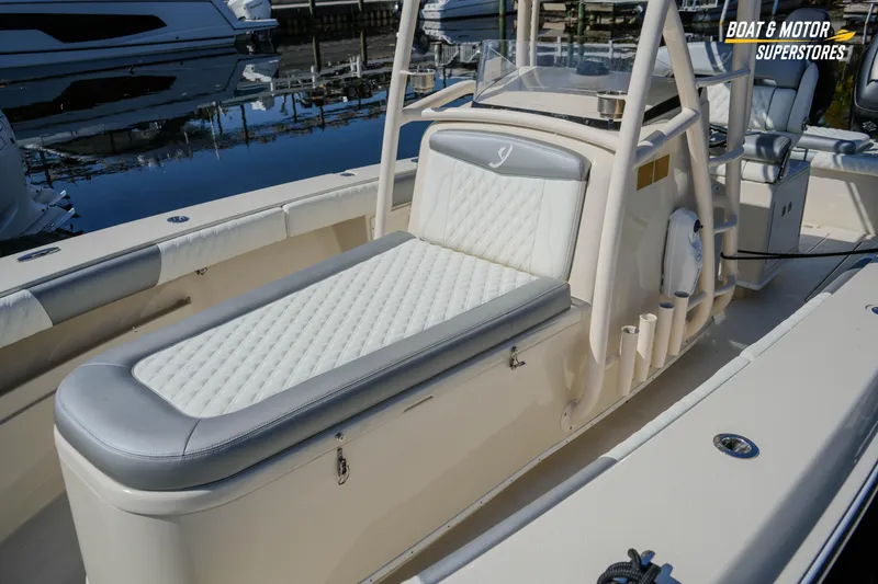 Slide: The Image of 2016 Young 27 boat with cushioned seating, docked at marina. - 11
