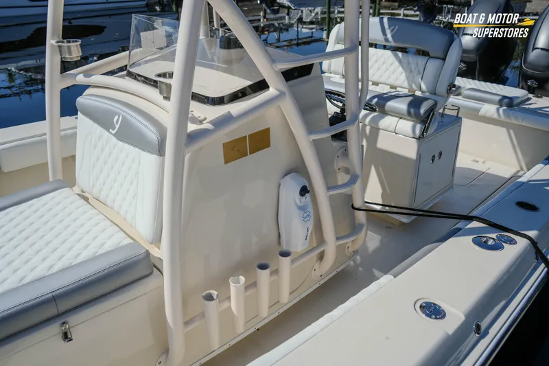 Slide: The Image of 2016 Young 27 boat interior with cushioned seating and rod holders. - 13