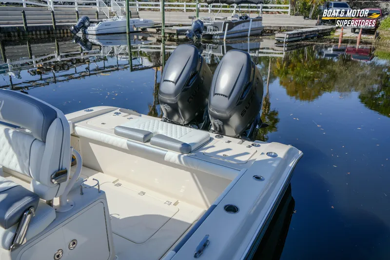 Slide: The Image of 2016 Young 27 boat with dual outboard motors docked at marina. - 15