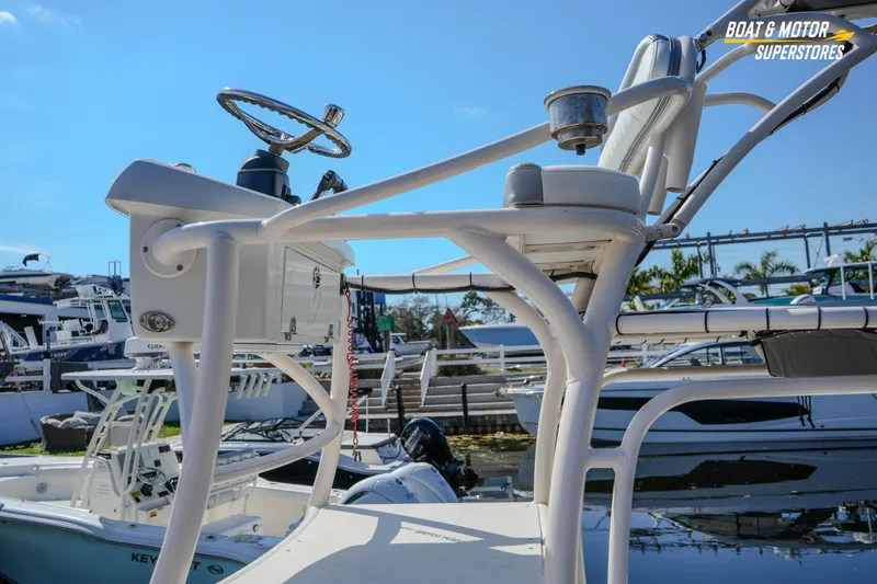 Slide: The Image of Boat steering console and seating on a 2016 Young 27 model at a marina. - 17