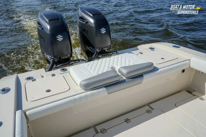Slide: The Image of 2016 Young 27 boat with dual Suzuki outboard motors on water. - 20
