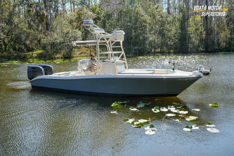 Slide: The Image of Boat on a serene lake, Young 27 model, 2016, surrounded by lush greenery. - 25